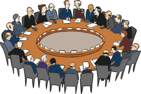 Viele Menschen sitzen an einem runden Tisch und besprechen sich.